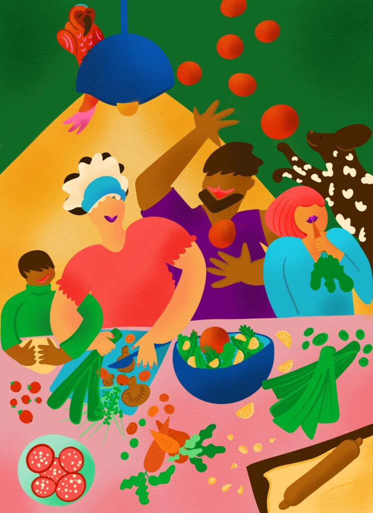 The illustration shows a family in the kitchen cooking together. There are pizza dough, salad, and vegetables on the table. And the family is laughing and having fun preparing their meal together. There is also their dog jumping and their parrot sitting above. The illustration has bold, vibrant, and warm colors.