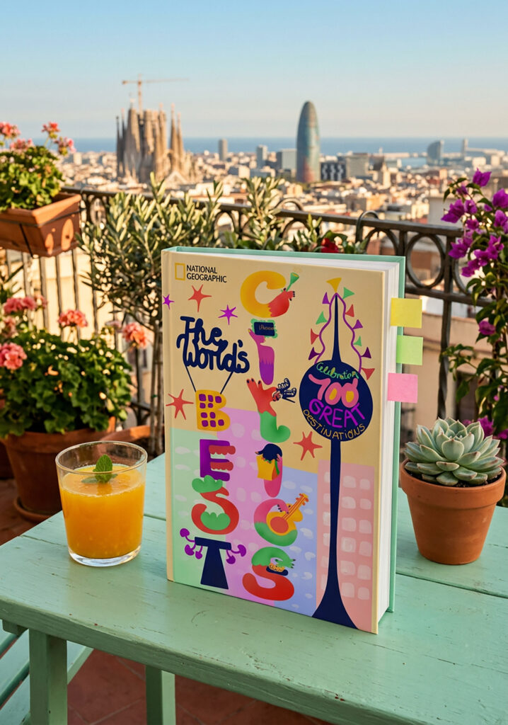 The image shows a book places on a green wooden table with a glass of orange juice. In the background the blurred silhouette of Barcelona can be seen. The book cover is an illustration. The illustration shows an illustrated book cover for the book "The World's Best Cities Celebrating 100 Great Destinations". The title is written in illustrated hand-lettering. The letter of the word Cities each show a different aspect of a city trip woven into the letter. Like going to a museum, having cocktails, trying street food, going shopping and attending a concert. The background shows high buildings in soft colors and a tower decorated with joyful flags. The colors are vibrant and warm.